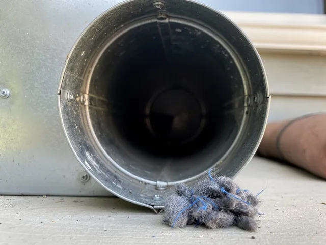 Richmond Heights Dryer Vent Cleaning technician using specialized equipment to clear severe dryer vent blockage in Richmond Heights